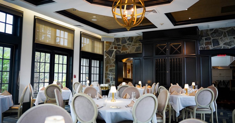 Interior, dining area, tables for four and six, stone decorated walls, carpet flooring