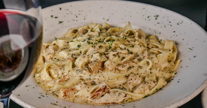 Chicken Fettuccine Alfredo with herb garnish