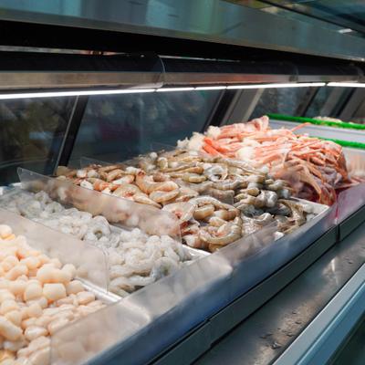 Fresh seafood in a refrigerated display case.