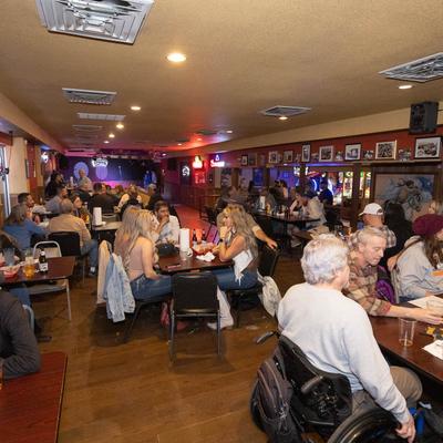 Customers sitting at tables in dining area.