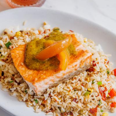 Salmon with bacon jam fried rice, verde sauce, and sweet and spicy peaches