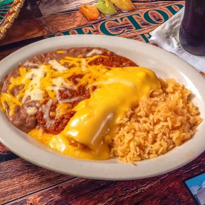 Enchilada covered in a chili-based sauce and melted cheese, served with rice and beans.