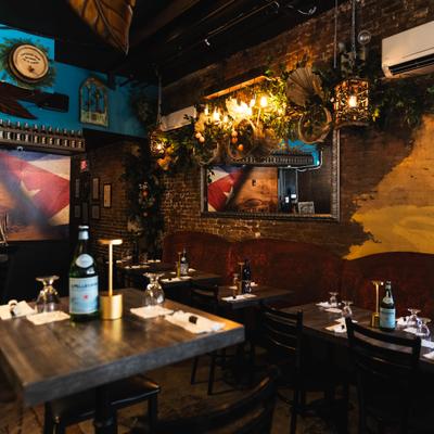 Restaurant interior with warm lighting and brick walls.
