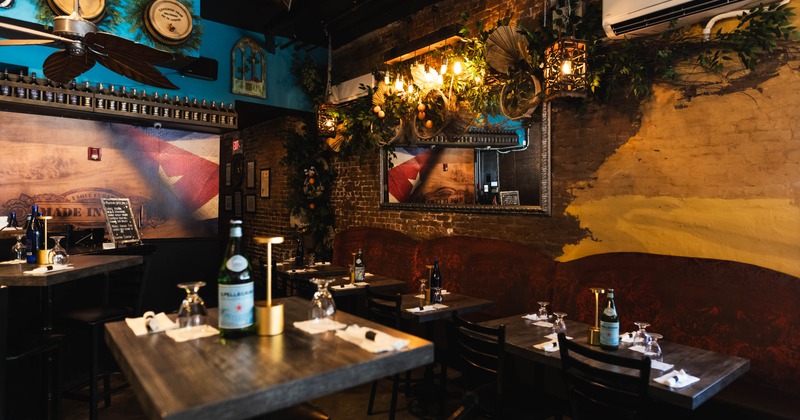 Interior with brick walls, wooden tables, and warm lighting