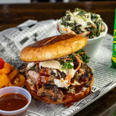 Chopped chicken sandwich with kale slaw and pickled peppers.