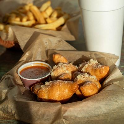 Garlic knots and marinara sauce served with fries.