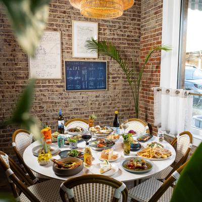 Table set with a variety of dishes and drinks at a restaurant.