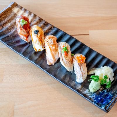 Aburi Sushi Appetizer served on a textured black plate.