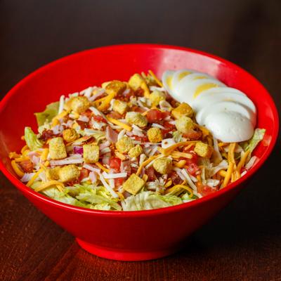 Chef salad in a red bowl.