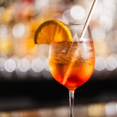 Aperol Spritz with blurry lights in the background.