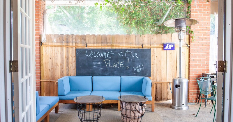 Covered patio, blue sofa, coffee tables, heat lamp
