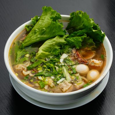 Rice noodle soup with pork wontons and bok choy.
