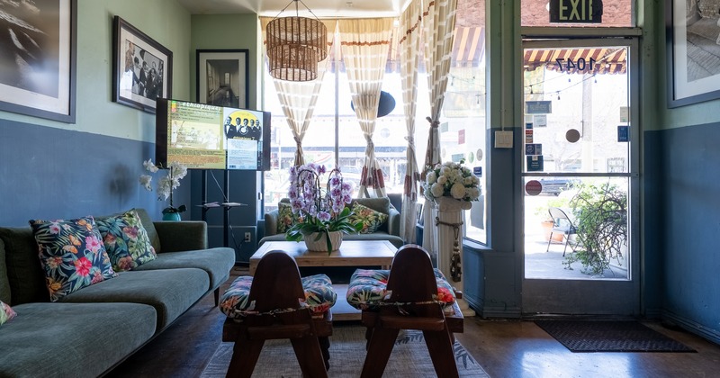 Interior, cozy seating space with orchid flowers and wall art