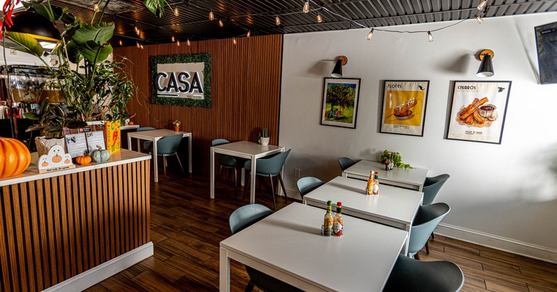 Cozy restaurant interior with white tables, and gray chairs