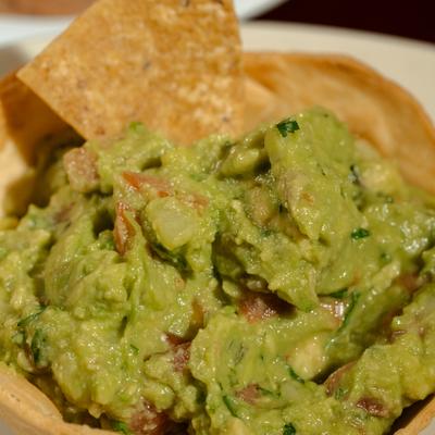 Guacamole with tortilla chips, close-up.