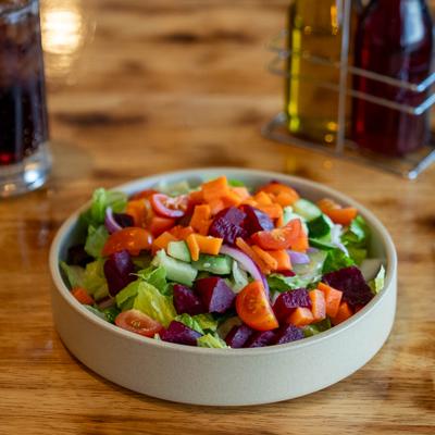 Mixed salad with lettuce, beets, tomatoes, cucumbers, carrots and onions.
