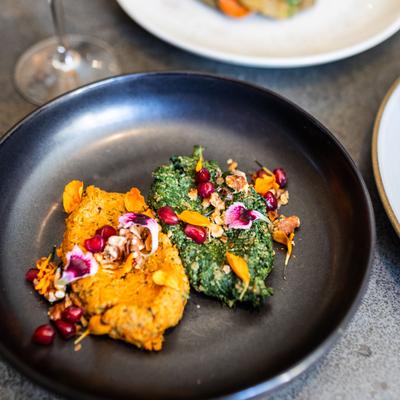 georgian dish called 'pkhali,' vegetable pates -- here carrot and spinach versions on dark gray plate