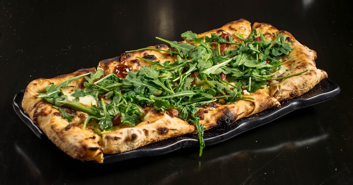 Fig Pizzette with Prosciutto, fresh mozzarella, gorgonzola, fig jam and arugula