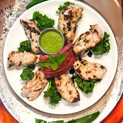 Grilled Chicken Kabab served with a dipping sauce.