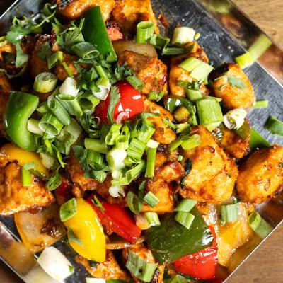 Boneless chicken cooked with spicy chili sauce, with mixed vegetables.