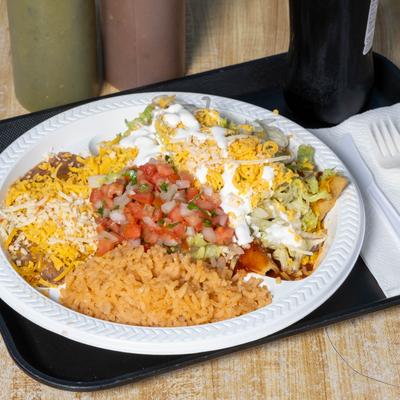 Enchiladas smothered in sauce, served with salsa, rice, and beans.