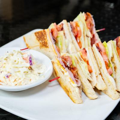 Club sandwiches served with coleslaw.