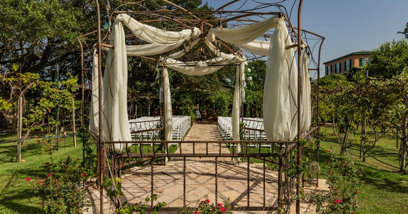 Exterior, outdoor wedding venue, lined up chairs, altar, vineyards around the venue