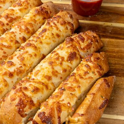 Cheesy Breadsticks with a side of marinara sauce, close-up.