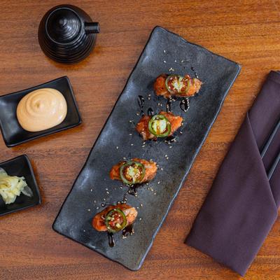 Crispy Rice Sushi Rolls, topped with spicy tuna, jalapeno, and eel sauce.