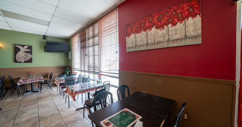 Interior, dining tables and chairs, TV screen on the wall