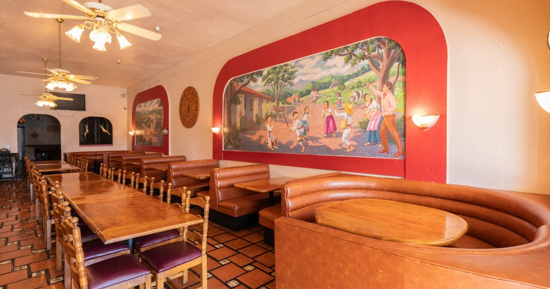 Interior, leather booths, dining tables, paintings on the wall