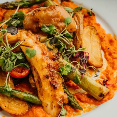 Grilled Octopus, with fingerling potatoes, asparagus, tomatoes, and Romesco sauce.