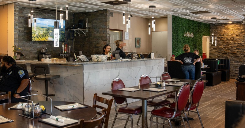 Interior, tables and chairs, bar in the back