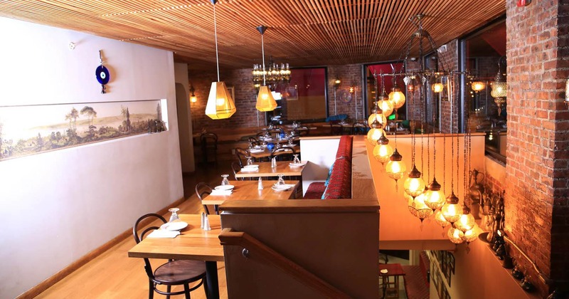 Interior with wooden decor, brick walls, and glowing lanterns