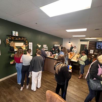 Bar area with people standing in line to order and receive drinks.