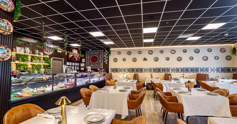 Modern and elegant interior dining area with set dining tables and brown leather chairs