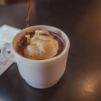 Cream coffee being poured