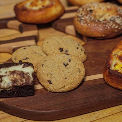 A variety of baked goods on a wooden board.
