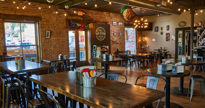 Interior, tables, chairs, decorative lighting, framed photos and ornaments on the walls