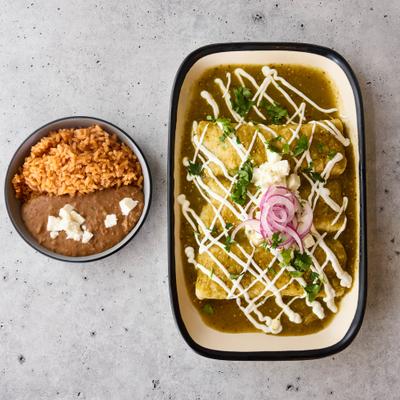 Enchiladas smothered in green salsa, served with rice and refried beans.