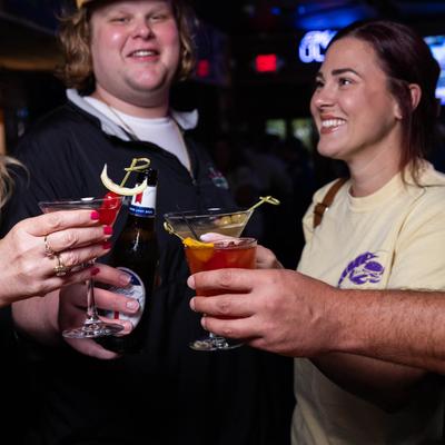A group of people toasts with drinks.