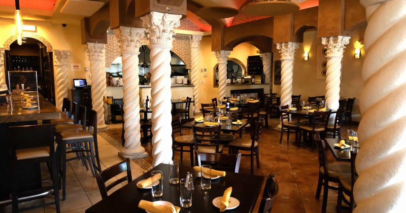 Interior with twisted columns and dark wooden furniture, dining area