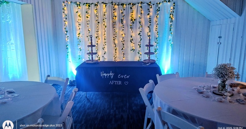 Interior with wooden tables and chairs, decorated for Christmas with stockings and garland