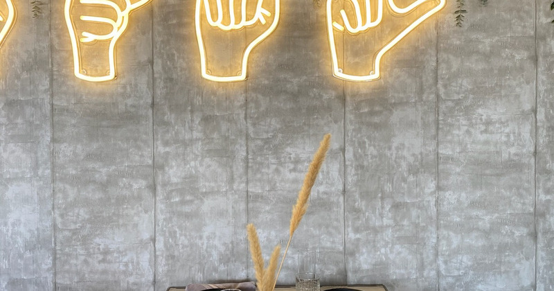 Neon hand sings on wall