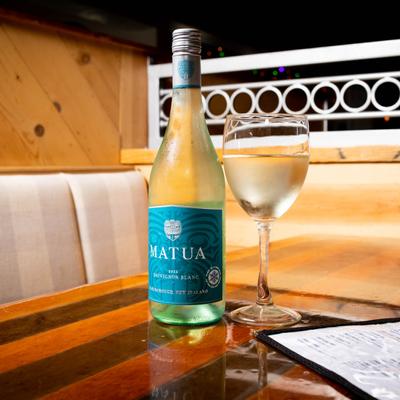 White wine bottle and glass served on a table