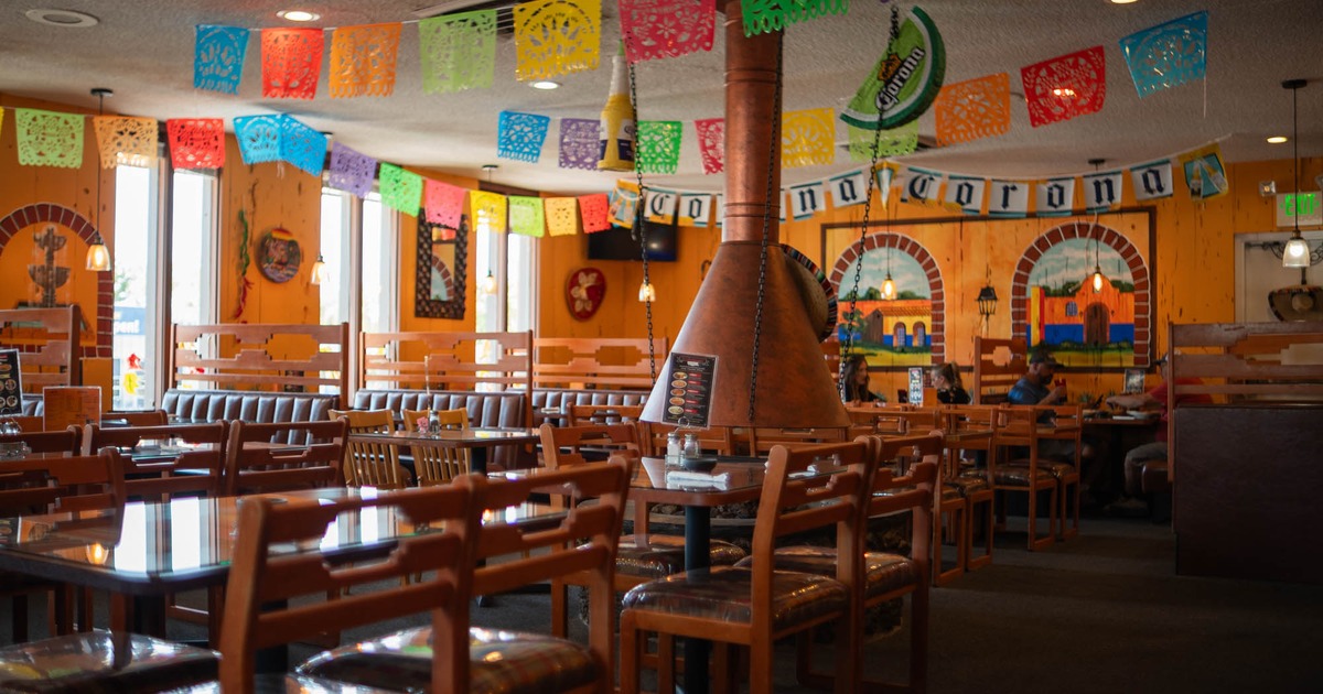 Interior of a Mexican restaurant with colorful decoration and wooden furniture