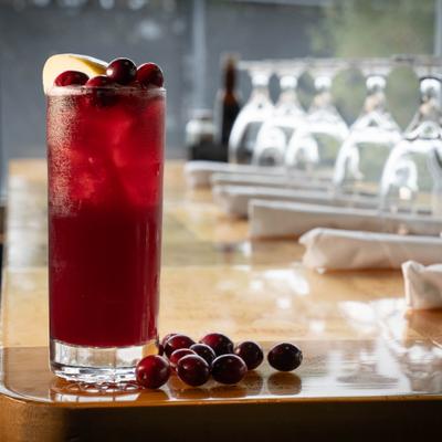 Cranberry sangria, served in a glass, front view.