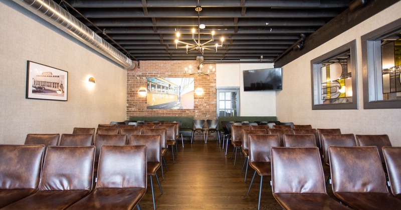 Interior, conference room, leather covered chairs lined up in the rows of four