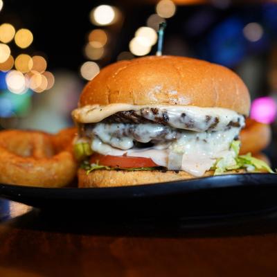 Classic smash burger served with onion rings.