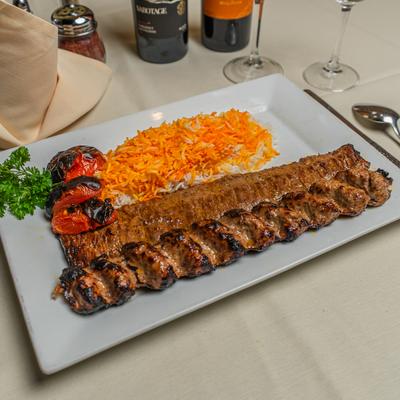 Combination of tender beef and ground beef kebab served with rice and roasted tomatoes.